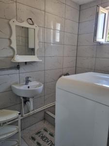 a white bathroom with a sink and a mirror at Ana LUX in Dobrosin +5 photos
