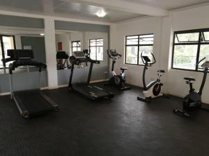 a gym with several exercise bikes in a room at Gae La Rona Self Catering Apartment in Gaborone