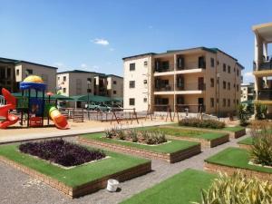 a park with a playground with a slide at Gae La Rona Self Catering Apartment in Gaborone