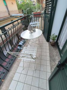 a white table and chairs on a balcony at Le perle 2 di Naxos in Giardini Naxos