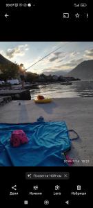 a picture of a picture of a person on a beach at Apartman Una Prcanj in Prčanj
