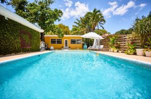 a swimming pool in front of a house at Resort-Style Home with Pool House in Miami