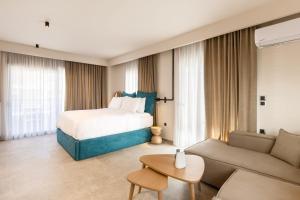 a hotel room with a bed and a couch at Kave luxurystaying in Volos