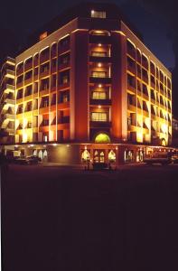 a large building at night with its lights on at Royal Court Hotel in Mombasa