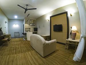 a living room with a couch and a tv at Najmi Inn Hotel in Kampong Burok