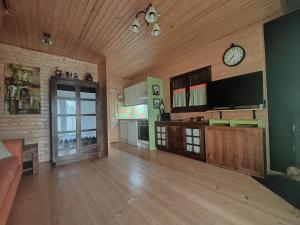 a large living room with a clock on the wall at Chalet en Eyne Cambre d'Aze in Eyne