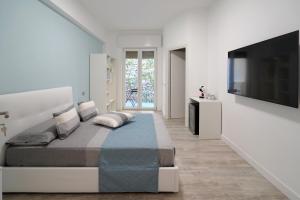 a bedroom with a large bed and a flat screen tv at Magic Dream Sea View-Private Beachfront Terrace in Meta