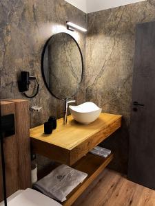 a bathroom with a sink and a mirror at Altfel Bran Chalet 2 in Bran +28 photos