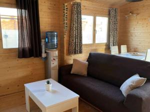 a living room with a couch and a coffee table at Bungalow Sol in Chiclana de la Frontera