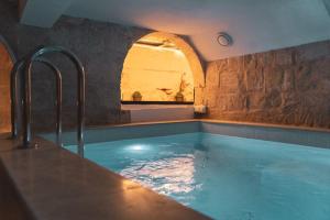 a bath tub with a water fountain in a room at NORMALT- luxurious stay in Il-Furjana