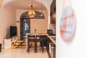 a kitchen with a table and chairs in a room at NORMALT- luxurious stay in Il-Furjana