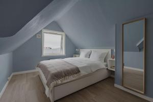 een slaapkamer met een bed, een raam en een spiegel bij Apartment in Tromsø City Centre in Tromsø