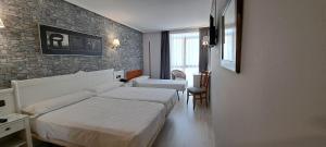 A bed or beds in a room at Hotel Ciudad Cangas de Onis