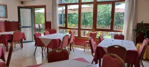 a restaurant with tables and chairs and a large window at Hotel Ciudad Cangas de Onis in Cangas de Onís