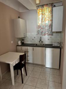 a small kitchen with a table and a sink at Emilios house in Dhërmi