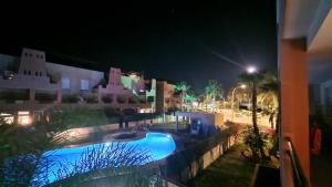 a view of a swimming pool at night at Apartamento junto al mar in Vera