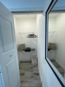 a hallway with a mirror next to a door at Golf Country Pool Home In Southern Dunes in Haines City