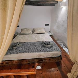 a bed in a room with curtains and a mattress at Frida' s Mansion in Dhragoulás