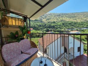 a balcony with a couch and a view at E&E Summer Breeze Apartment in Igalo