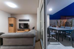 a living room with a couch and a dining table at Casa Coral in Crno
