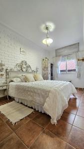 a bedroom with a white bed and a window at LasvistasdeLola in Combarro +25 photos