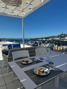 a table with two plates of food on a balcony at Misk Villa - Boutique Hotel & Spa in Sidi Bou Saïd