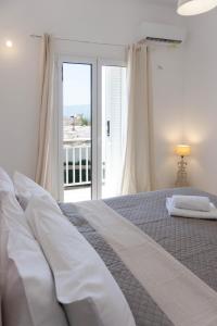 a bedroom with a bed with a view of the ocean at Spacious seaview apartment in Heraklion in Heraklio