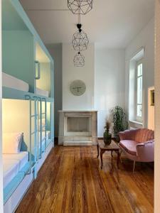 a living room with a couch and a fireplace at Pink Lemon in Athens