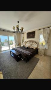 a large bedroom with a large bed and a chandelier at Sea Marbella in Marbella