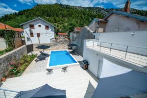 a view of the pool from the balcony of a house at Vila Hana in Stolac