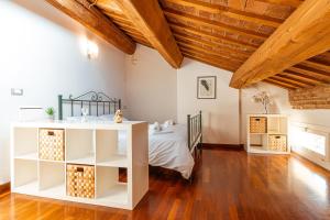 Un dormitorio con una cama y un techo de madera. en Mansarda Magellano - Parcheggio Auto, en Ferrara