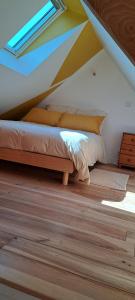 a bedroom with a bed in a attic at Panarama maison neuve superbe vue in Gouffern en Auge