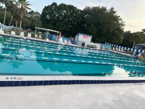 a swimming pool with a reflection in the water at Tranquility Home near Beaches in Palm Coast