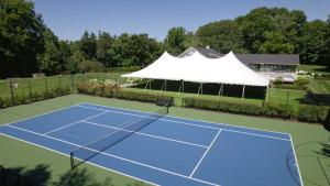 an overhead view of a tennis court with a tent at Apple Blossom Resort By Dwell Vacations in New Buffalo +57 photos