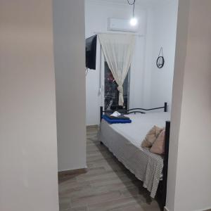 a bedroom with a bed and a television in it at small STUDIO center 2 in Thessaloniki +14 photos