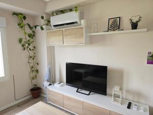 a living room with a large flat screen tv at PASARELA ALMOZARA HOME & Parking gratis in Zaragoza