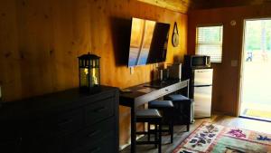a kitchen with a desk with a microwave and a refrigerator at Gold Creek Cabin 3 - Sleeps up to 4 in O'Brien