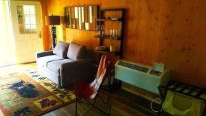 a living room with a couch and a table at Summer Trail Cabin 5 - Sleeps up to 4 in O'Brien