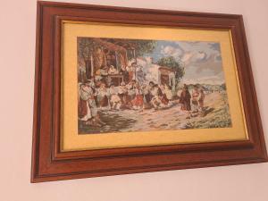a picture of a painting of a group of people at Eva Apartments Mall 90mp in Bacău