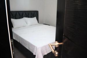 a bed with white sheets and a black headboard at Zen Oaza in Konjic +11 photos