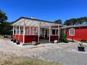 a red house with a pavilion in front of it at Rønne Vandrerhjem in Rønne