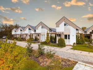 a large white house with a lot of windows at Holiday Home in Niechorze near Baltic Beach in Niechorze