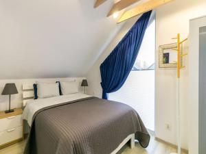 a bedroom with a bed and a large window at Holiday Home in Niechorze near Baltic Beach in Niechorze +21 photos