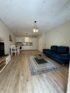 a living room with a blue couch and a table at Smart Rent Apartments 2 in Tirana +8 photos