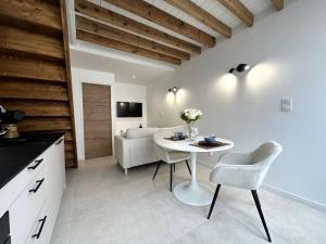 a kitchen and living room with a table and chairs at Gare Unique Duplex lumineux in Amiens
