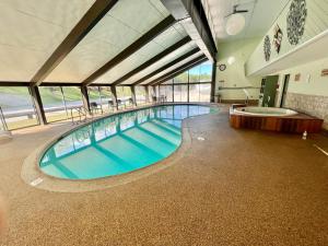 a large indoor swimming pool in a building at Town & Country Inn & Resort in Gorham