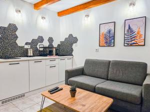 a living room with a couch and a table at GlowLeaf Loft in Sarajevo +10 photos