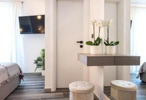 a bedroom with a table with flowers and stools at Apartment Jasna in Splitska