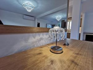 a glass lamp sitting on top of a wooden table at Elite Country House in Ialysos +33 photos