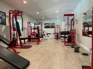 a gym with lots of treadmills and machines at Town & Country Inn & Resort in Gorham